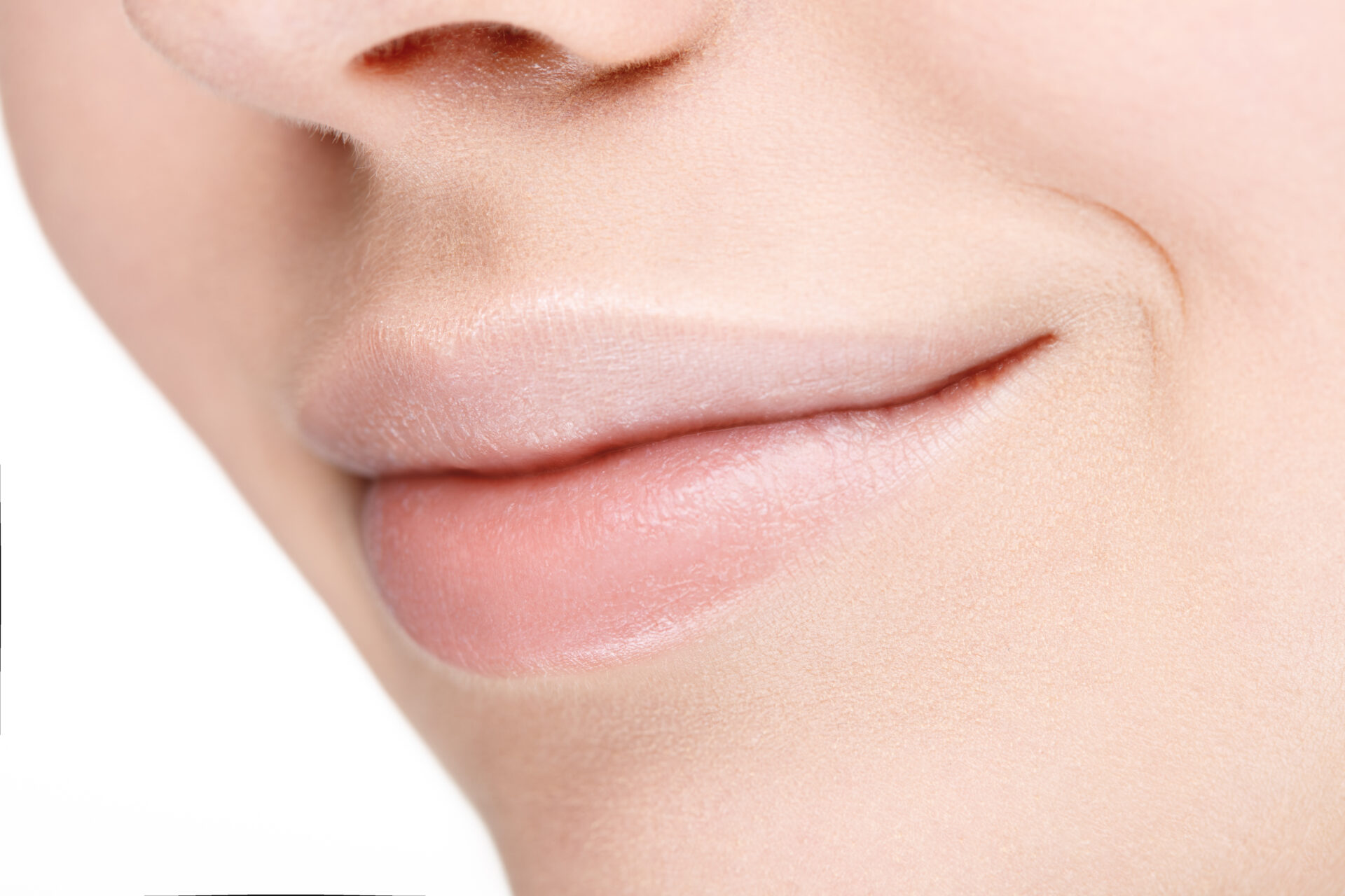 Part of face with beautiful full lips without makeup.
