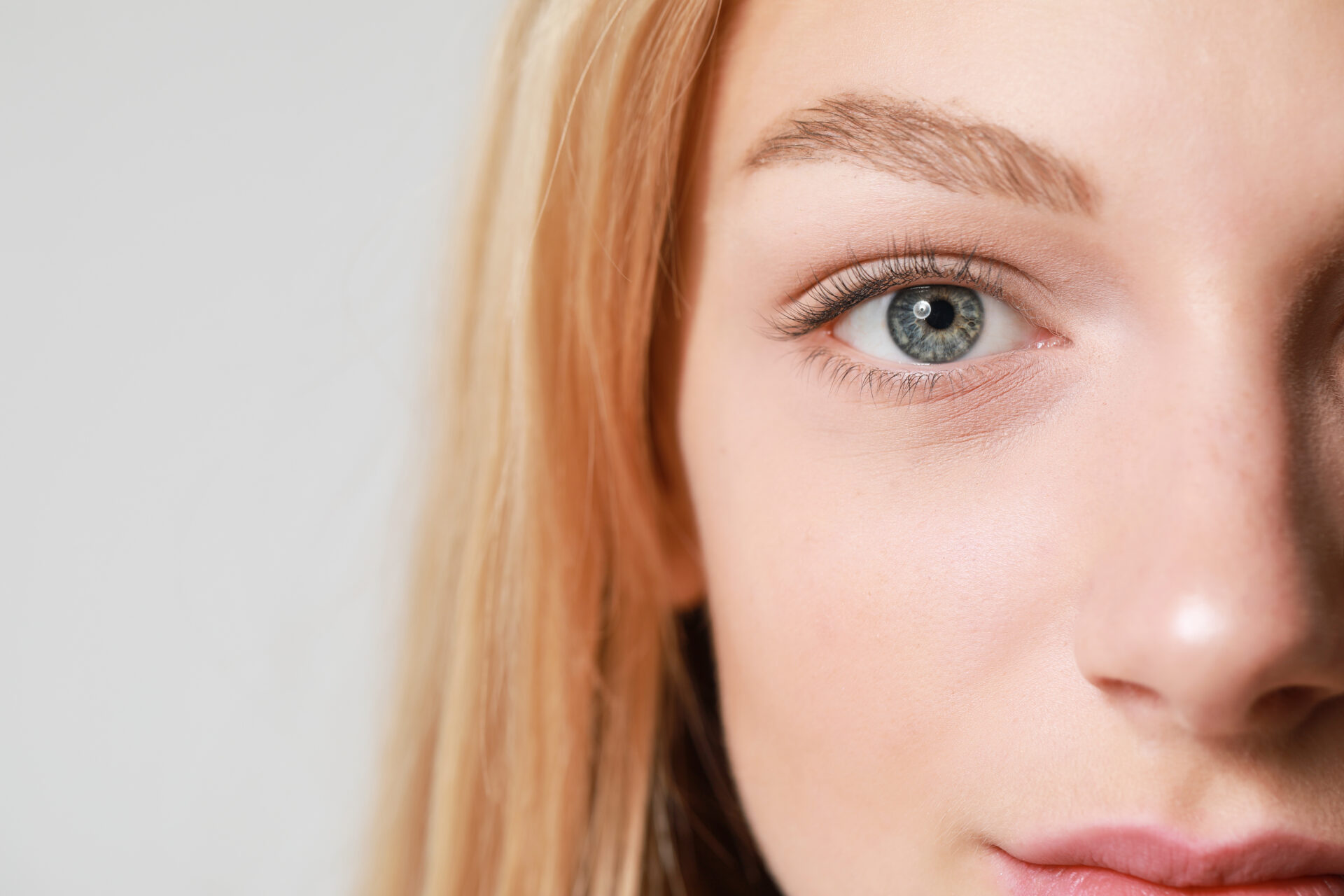 Beautiful young woman after eyelashes lamination and dyeing, clo